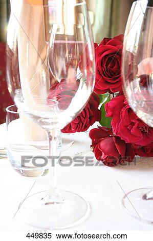 Stem glasses and bunch of roses on table View Large Photo Image Stock Photography - Stem glasses and bunch of roses on table . Fotosearch