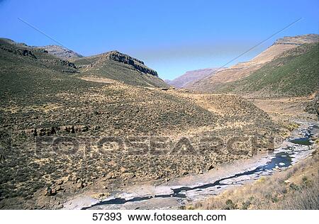 Stock Image - Stream flowing through a landscape, Lesotho, Southern Africa . Fotosearch