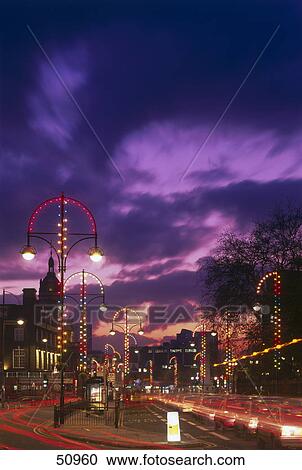 Stock Image - Street scene in city at dusk, Stratford, London Borough of Newham, London, England . Fotosearch