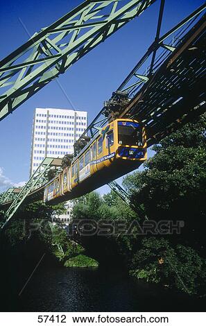 Stock Image - Suspension monorail over bridge, Wuppertal Schwebebahn, River Wupper, Wuppertal, North Rhine-Westphalia, Germany . Fotosearch