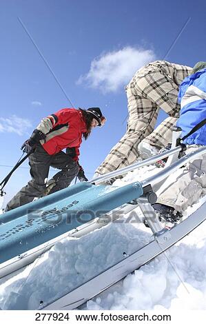 Three people climbing snowy mountain View Large Photo Image Picture - Three people climbing snowy mountain . Fotosearch