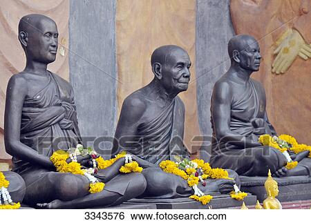 Three statues with flower arrangement, Amulet Market, Bangkok, Thailand View Large Photo Image Stock Photograph - Three statues with flower arrangement, Amulet Market, Bangkok, Thailand . Fotosearch