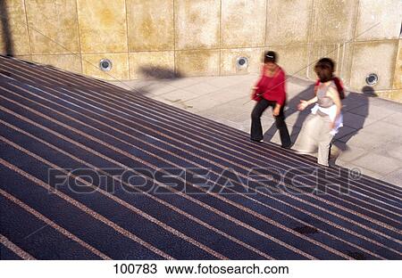Stock Image - Three women walking up on stairs . Fotosearch