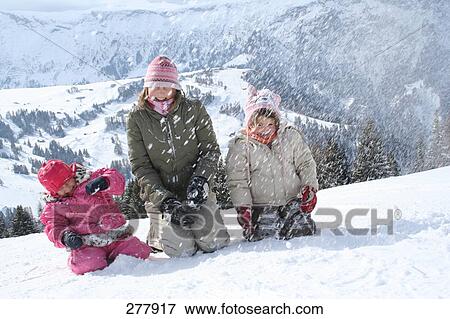 Three young people having a snowball fight View Large Photo Image Stock Photo - Three young people having a snowball fight . Fotosearch