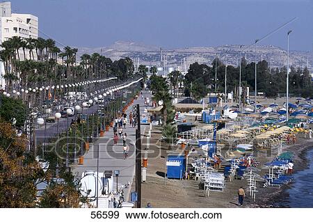 Stock Photo - Tourist walking at promenade on beach, Larnaca, Cyprus . Fotosearch