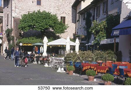 Tourists at outdoor cafe, Lake Garda, Sirmione, Lombardy, Italy View Large Photo Image Stock Image - Tourists at outdoor cafe, Lake Garda, Sirmione, Lombardy, Italy . Fotosearch