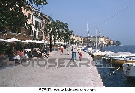 Stock Image - Tourists at the sea side, Salo, Lake Garda, Italy . Fotosearch