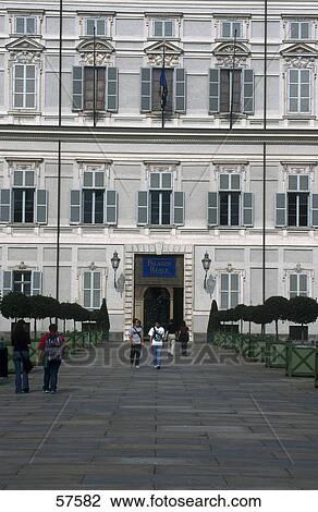 Stock Image - Tourists in front of palace, Royal Palace Of Turin, Turin, Piedmont, Italy . Fotosearch
