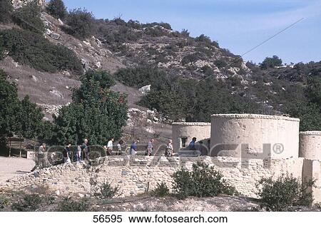 Stock Photography - Tourists near round cottages, Khirokitia, Larnaca, Cyprus . Fotosearch