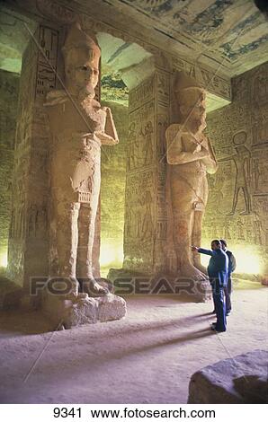 Stock Image - Tourists near statues in temple, Temple Of Ramses, Abu Simbel, Egypt . Fotosearch