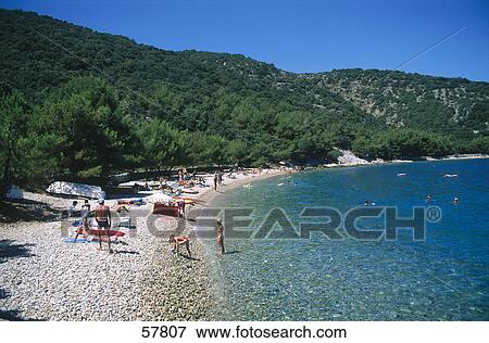 Stock Photo - Tourists on beach, Cres Island, Croatia . Fotosearch