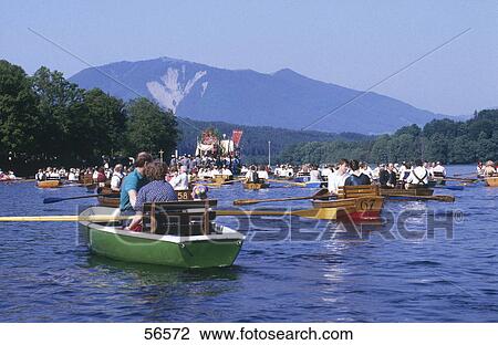 Stock Image - Tourists on boats in lake, Staffelsee Lake, Seehausen, Bavaria, Germany . Fotosearch