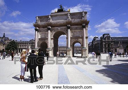 Stock Photograph - Tourists standing in front of triumphal arch, Arc de Triomphe du Carrousel, Paris, Ile-de-France, France . Fotosearch
