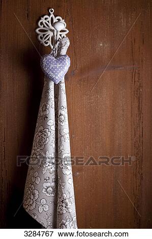 Towel and heart hanging on a wall View Large Photo Image Stock Photo - Towel and heart hanging on a wall . Fotosearch
