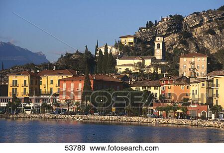 Stock Photo - Town at waterfront, Lake Garda, Torbole, Veneto, Italy . Fotosearch