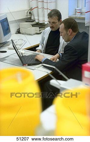 Stock Photo - Two doctors using laptop . Fotosearch