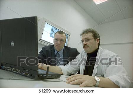Stock Photo - Two doctors using laptop . Fotosearch