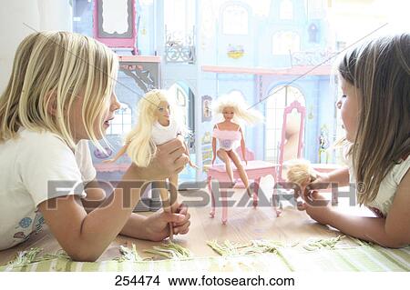Two girls playing with barbie dolls View Large Photo Image Picture - Two girls playing with barbie dolls . Fotosearch