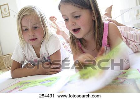 Stock Image - Two girls reading . Fotosearch
