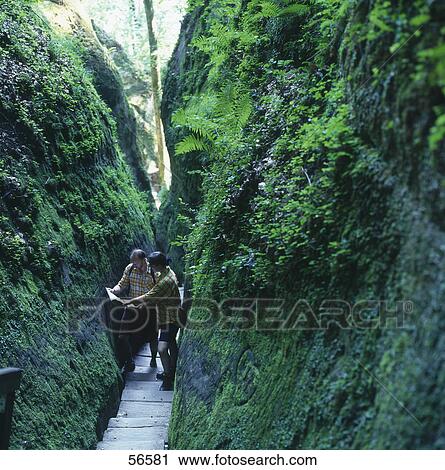 Stock Image - Two hikers with map on boardwalk, Baden-Wurttemberg, Germany . Fotosearch