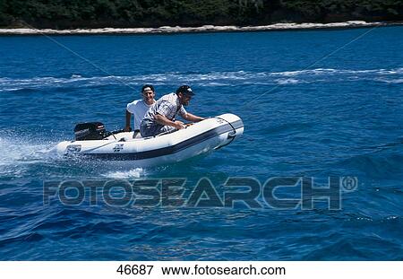 Stock Photo - Two men on rubber boat in water, Susak, Istrien, Kvarner Bay, Croatia . Fotosearch