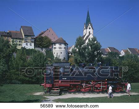 Stock Photo - Two people near steam locomotive engine in garden, Baden-Wurttemberg, Germany . Fotosearch