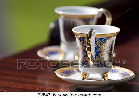Two tea cups on a table, close-up View Large Photo Image Stock Photograph - Two tea cups on a table, close-up . Fotosearch