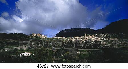 Village with mountain ranges in background, Valldemossa, Majorca, Balearic Islands, Spain View Large Photo Image Stock Photo - Village with mountain ranges in background, Valldemossa, Majorca, Balearic Islands, Spain . Fotosearch