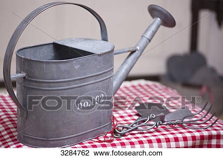 Watering can and creative gardening accessory, close-up View Large Photo Image Stock Image - Watering can and creative gardening accessory, close-up . Fotosearch