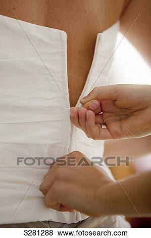 Woman closing zipper of corsage View Large Photo Image Stock Photo - Woman closing zipper of corsage . Fotosearch