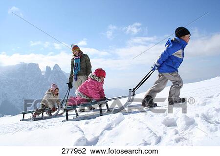 Woman with her three children on snow View Large Photo Image Stock Image - Woman with her three children on snow . Fotosearch