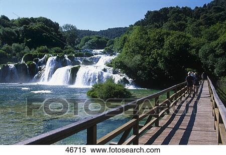 Wooden bridge across river, Skradinski buk River, Krka National Park, Dalmatia, Croatia View Large Photo Image Stock Photography - Wooden bridge across river, Skradinski buk River, Krka National Park, Dalmatia, Croatia . Fotosearch