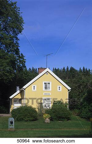 Picture - Wooden house in village, Lyrestad, Mariestad, Vastra Gotaland County, Sweden . Fotosearch