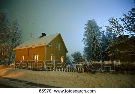 Stock Photo - Wooden house lit up at dusk, Finland . Fotosearch