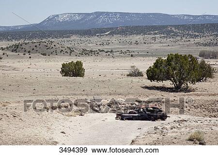 Stock Photo - Wrecked car in a landscape, New Mexico, USA, elevated view . Fotosearch