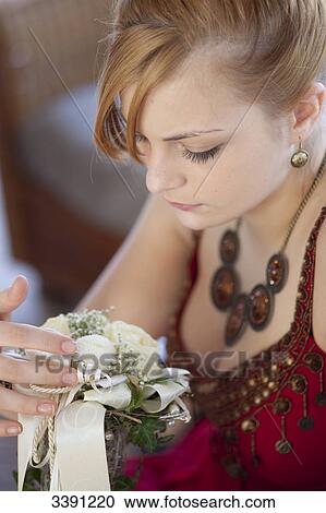 Young woman holding a bridal bouquet, close-up View Large Photo Image Stock Image - Young woman holding a bridal bouquet, close-up . Fotosearch