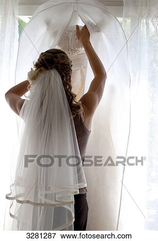 Stock Photo - Young woman with bridal veil in her hair, rear view . Fotosearch