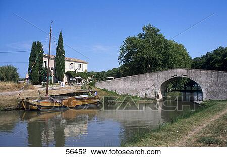 Boat in canal near bridge, Canal du Midi, France View Large Photo Image Stock Image - Boat in canal near bridge, Canal du Midi, France . Fotosearch