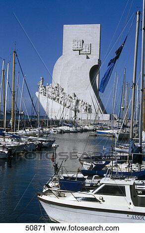 Boats at harbor with monument in background, Port of Lisbon, Monument to the Discoveries, Lisbon, Portugal View Large Photo Image Stock Image - Boats at harbor with monument in background, Port of Lisbon, Monument to the Discoveries, Lisbon, Portugal . Fotosearch