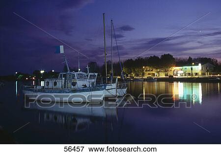 Boats in harbor at dusk, Orb River, Herault, France View Large Photo Image Stock Photo - Boats in harbor at dusk, Orb River, Herault, France . Fotosearch