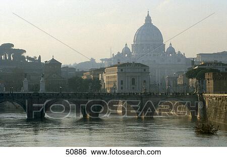 Stock Photograph - Bridge across river with church in background, Ponte Sant'Angelo, Tiber River, St. Peter's Basilica, Vatican, Rome, Italy . Fotosearch