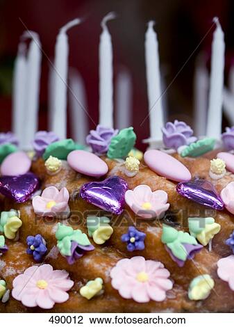 Close-up of flower and heart shape candies on cake View Large Photo Image Stock Image - Close-up of flower and heart shape candies on cake . Fotosearch