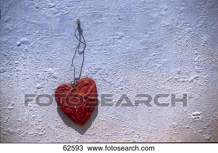 Close-up of heart shape ornament hanging on wall View Large Photo Image Stock Image - Close-up of heart shape ornament hanging on wall . Fotosearch