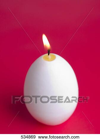 Close-up of lit egg shaped candle View Large Photo Image Stock Photo - Close-up of lit egg shaped candle . Fotosearch