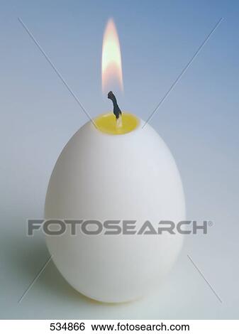 Close-up of lit egg shaped candle View Large Photo Image Stock Photograph - Close-up of lit egg shaped candle . Fotosearch