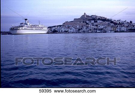 Stock Photography - Cruise ship anchored near city at dusk, Ibiza, Spain . Fotosearch