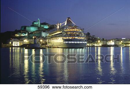 Cruise ship lit up at dusk, Ibiza Island, Spain View Large Photo Image Stock Photograph - Cruise ship lit up at dusk, Ibiza Island, Spain . Fotosearch