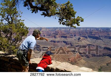 Father and son enjoying the view over the Grand Canyon, USA View Large Photo Image Stock Image - Father and son enjoying the view over the Grand Canyon, USA . Fotosearch
