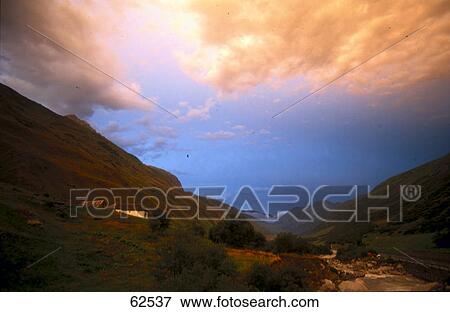 Stock Photo - High angle view of valley at dusk, Alps mountain range, Switzerland, Europe . Fotosearch