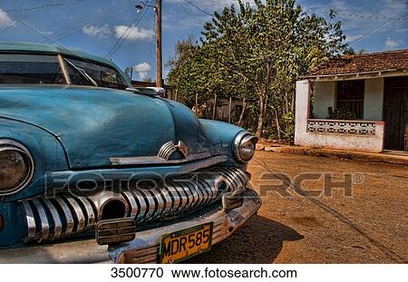 Local home and vintage car on street, Isabel, Cuba View Large Photo Image Stock Image - Local home and vintage car on street, Isabel, Cuba . Fotosearch